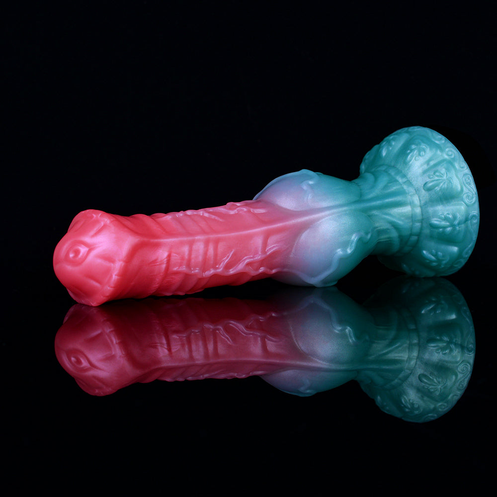 Fantasy animal sex toy in teal and pink, sculpted monster head and ridged shaft, angled