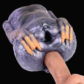 Dual-hole animal-themed fleshlight with textured purple body and orange finger-like grips