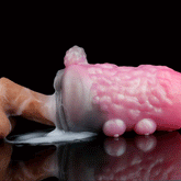 Pink and light-purple animal-themed sex toy with textured body and rounded bumps