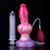 Realistic pink dog-shaped squirting dildo with tubing and pump, beside measurement syringe