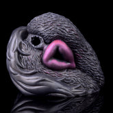 Dual-hole animal-themed vibrating masturbator, dark textured gray with purple insert