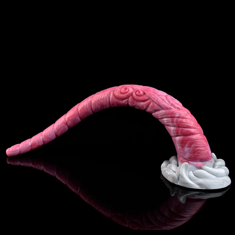 Pink curved tentacle-style butt plug with white base, lying in a C shape