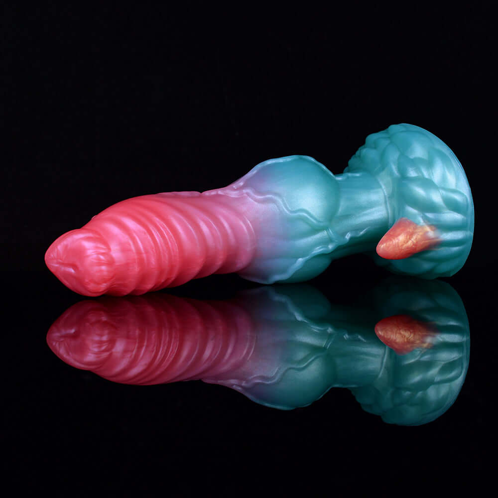 Alien dog dildo with teal base and pink ribbed shaft, horned head detail