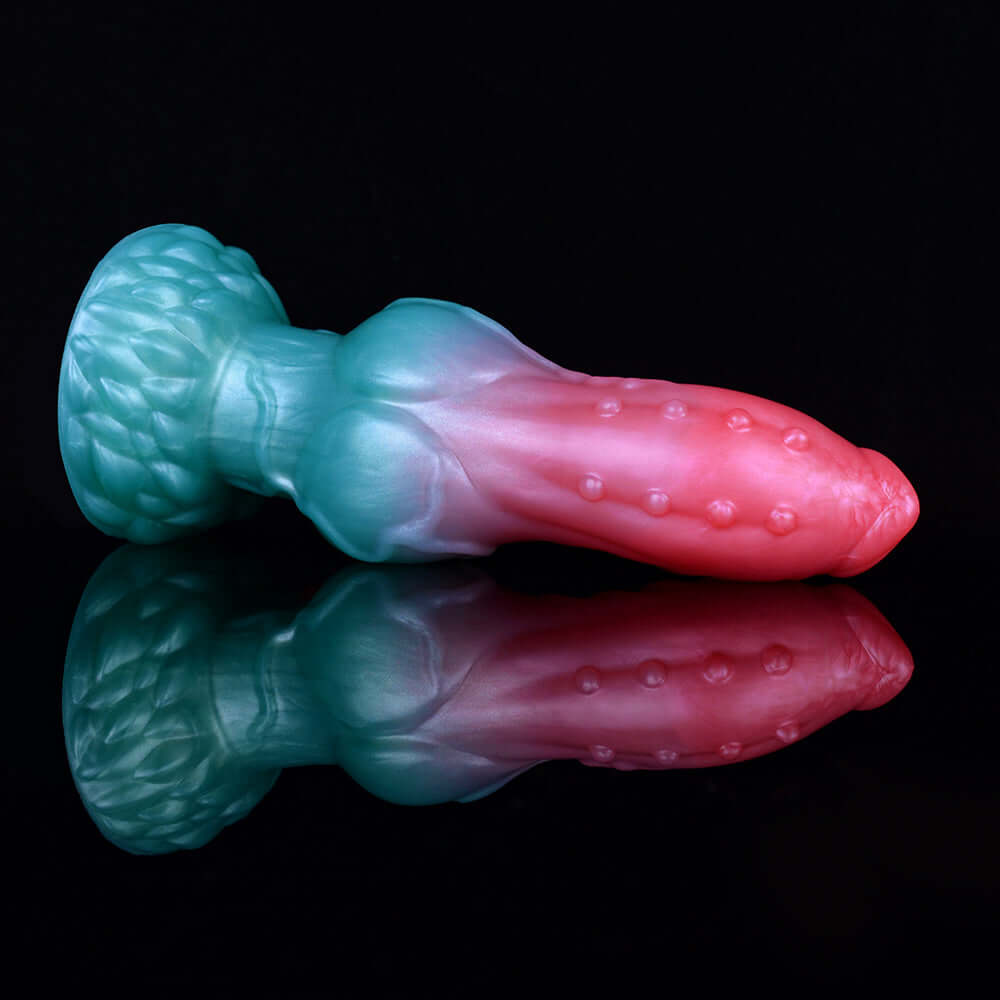 Teal-and-pink alien dog dildo with bubbled texture along the pink tip
