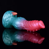 Side view alien dildo: teal body with pink knotted shaft and horned head