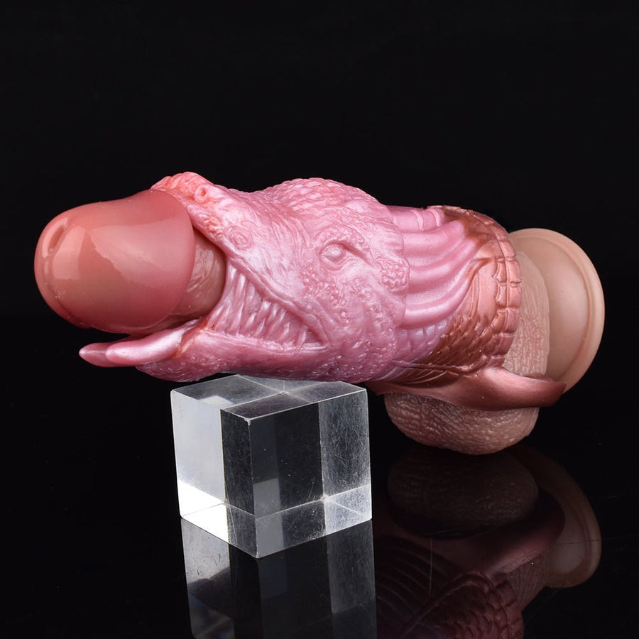 Pink dragon penis sleeve toy with textured scaly details and curved opening