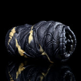 Rear side of the black textured dual-hole stroker with gold stripe highlights
