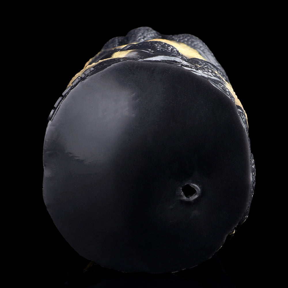 Bottom end of the black textured dual-hole stroker with a small port opening