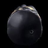Bottom end of the black textured dual-hole stroker with a small port opening