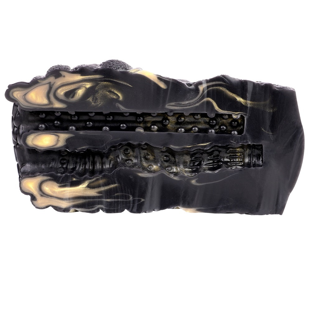Side profile of the black textured vibrating stroker with gold accents along the body