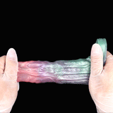 Cock sleeve with open ring base and long textured body in pastel pink, purple, and teal