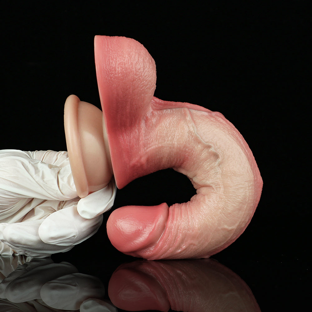 Realistic pink penis dildo with suction base; close view of base and underside.