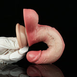 Realistic pink penis dildo with suction base; close view of base and underside.