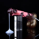 Unicorn dildo with pink marbled shaft and suction base; small nozzle on left