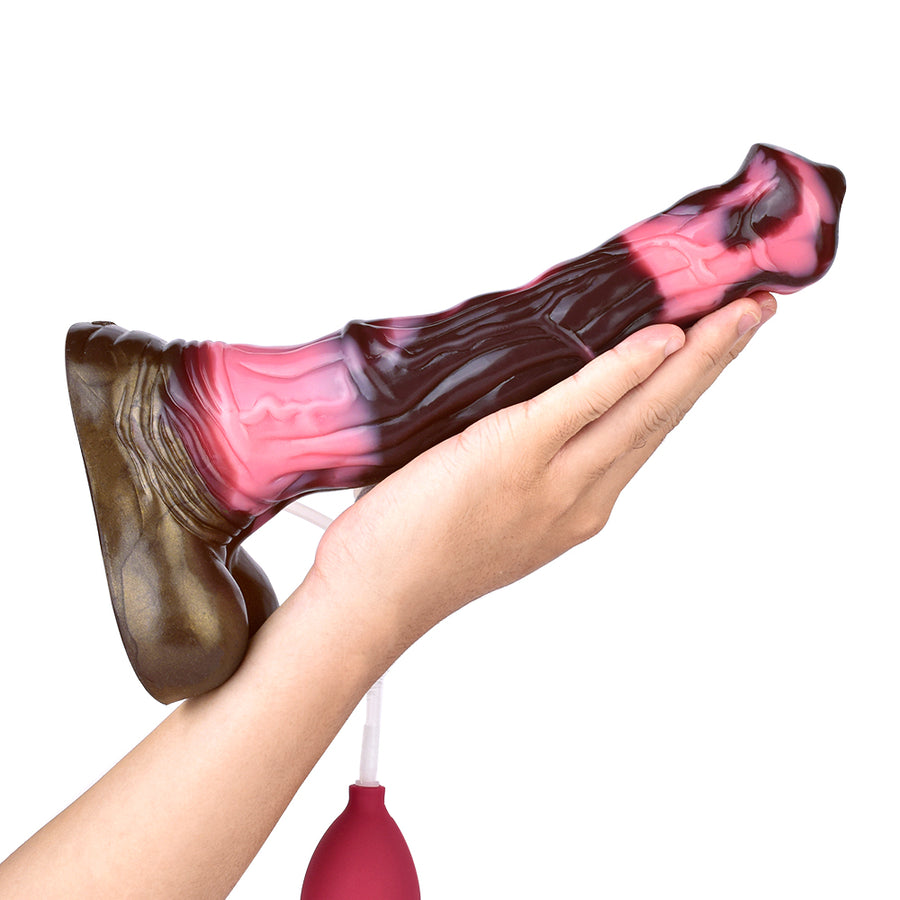 Unicorn-shaped sex toy dildo with clear tube and red bulb attachment held in hand