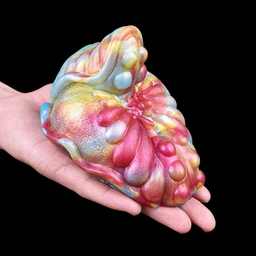 Rainbow iridescent adult massager toy with curved, textured surface held in hand