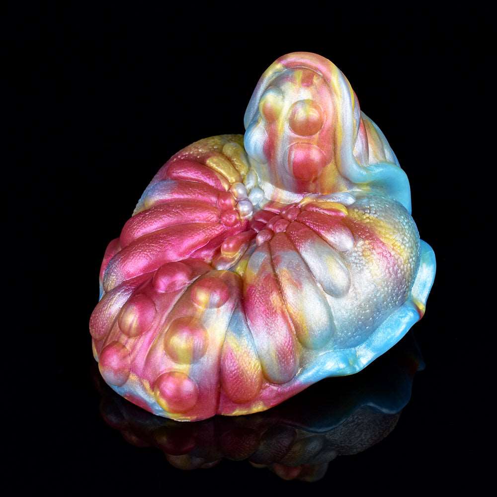 Close-up of iridescent grinder toy petals and raised central dome
