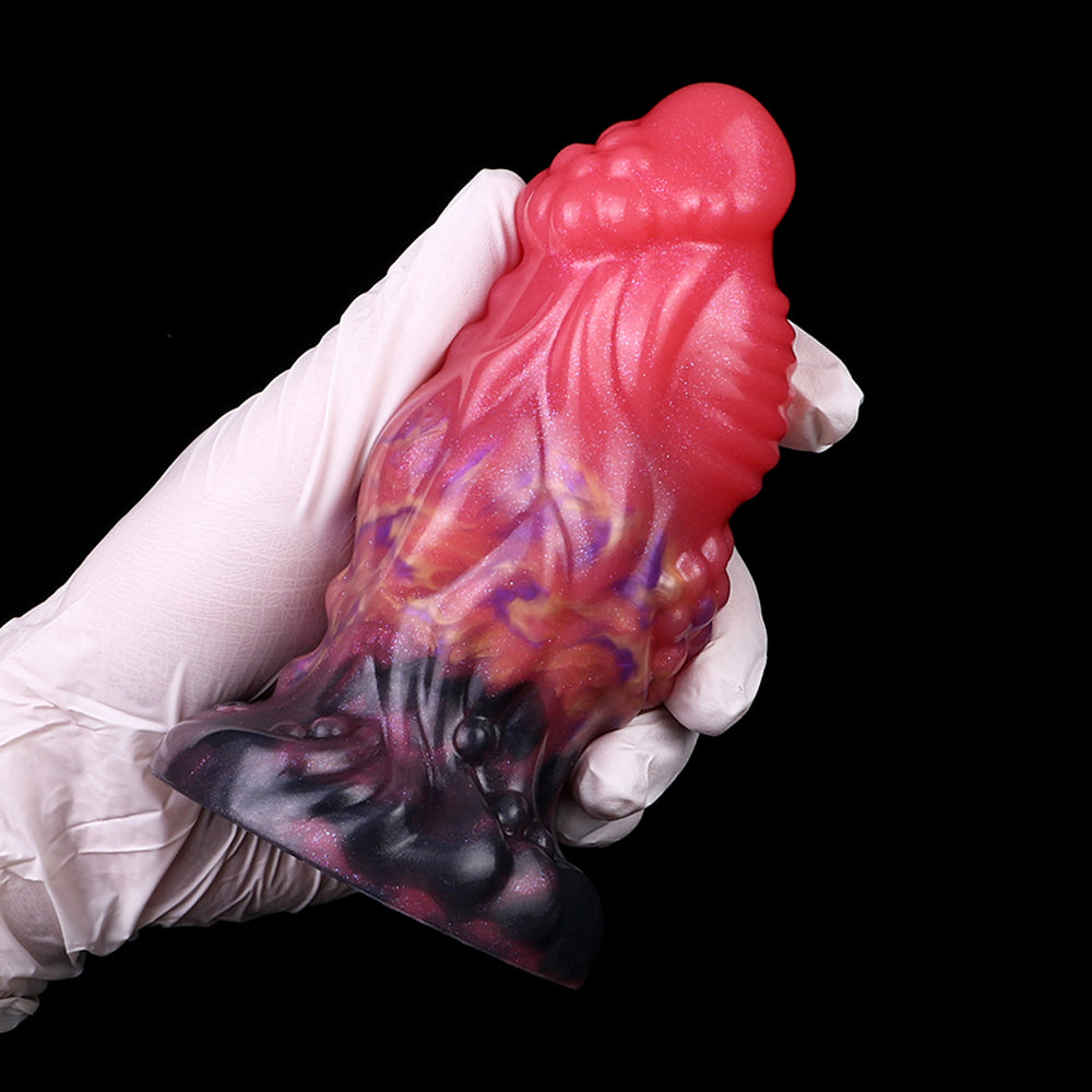 Pink and purple alien anal plug in white gloves, dark base, galaxy swirl pattern