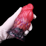 Pink and purple alien anal plug in white gloves, dark base, galaxy swirl pattern