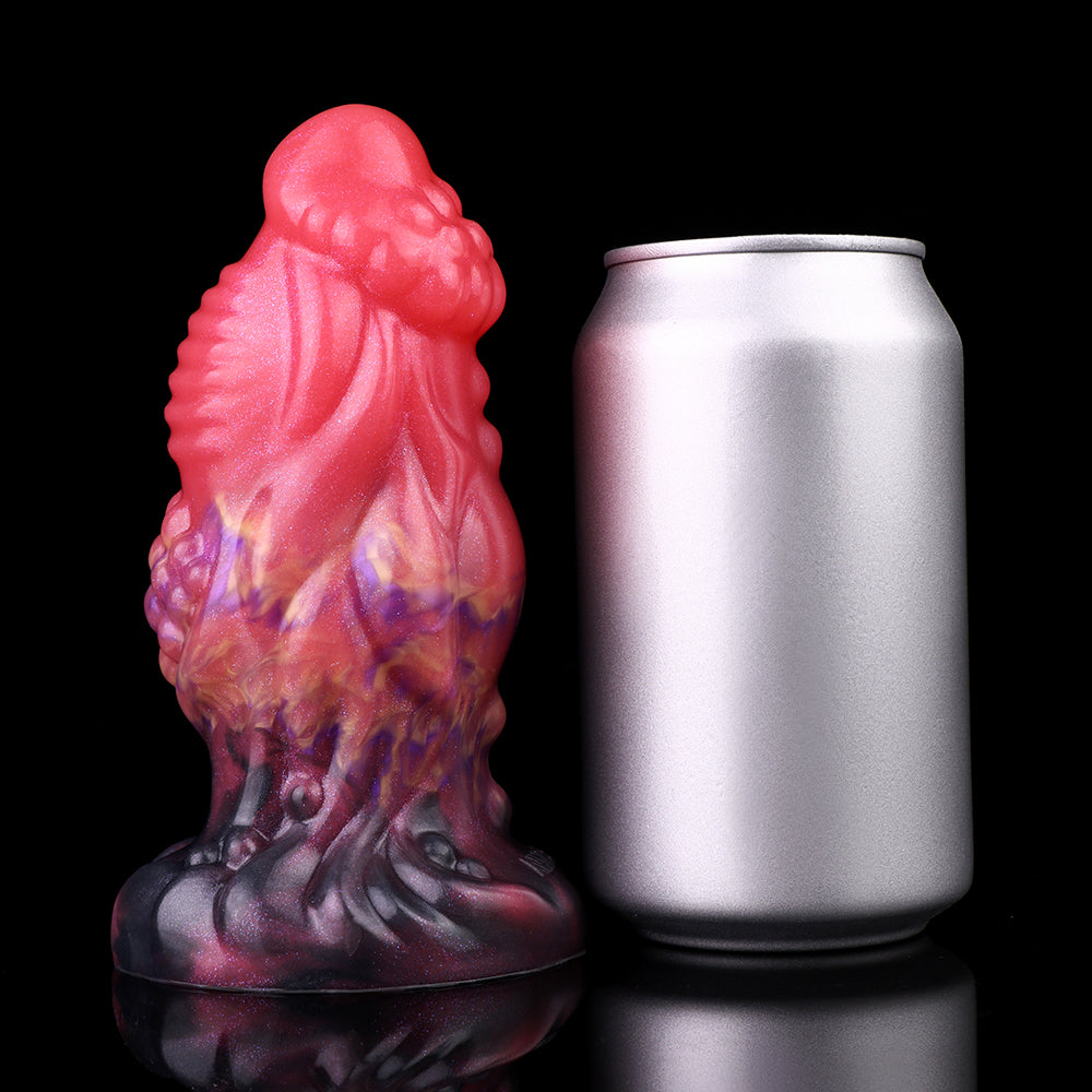 Pink alien anal plug with black base, galaxy swirls; shown next to a can for scale