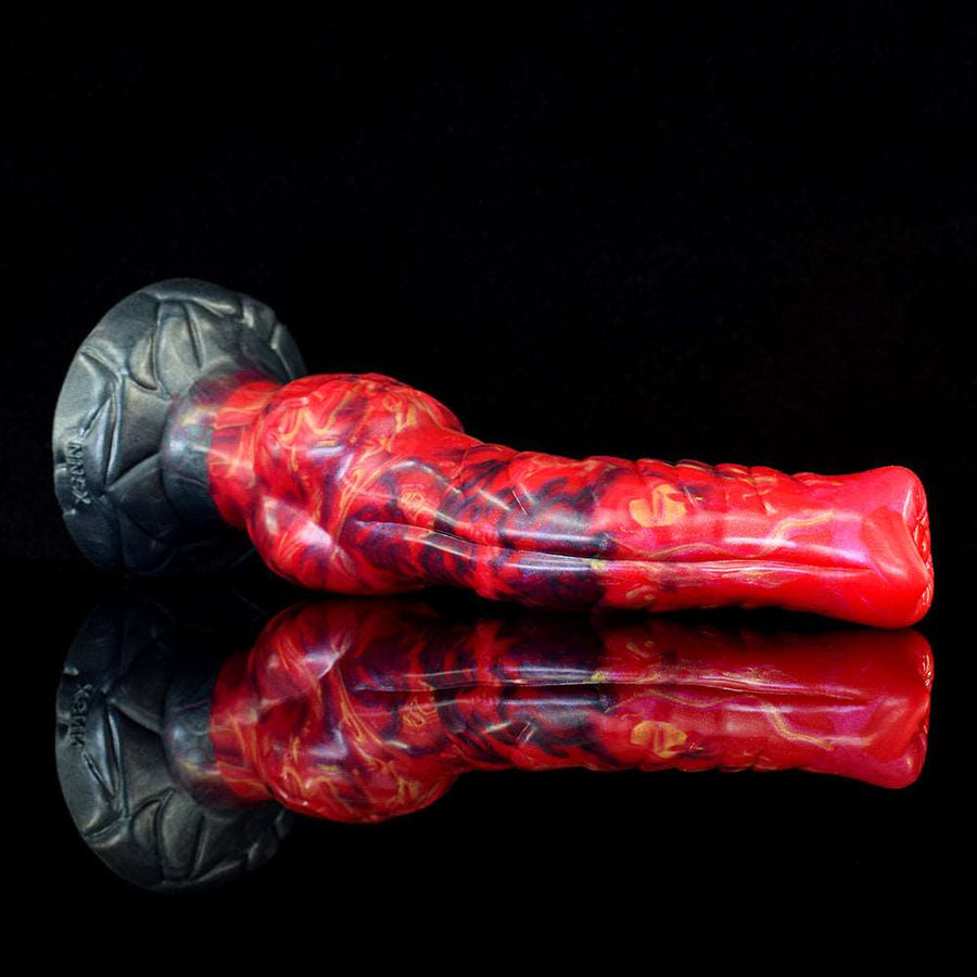 Red marbled ribbed dildo lying on dark textured suction base
