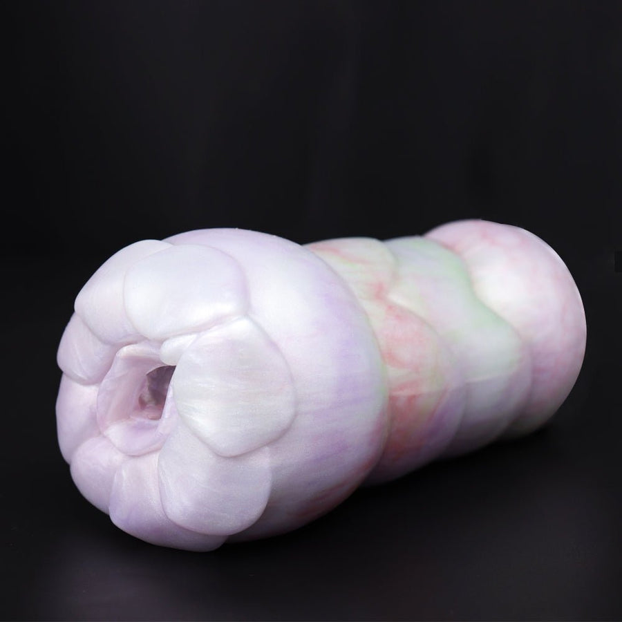 Pastel white silicone stroker with sculpted folds and cupped opening, side view.