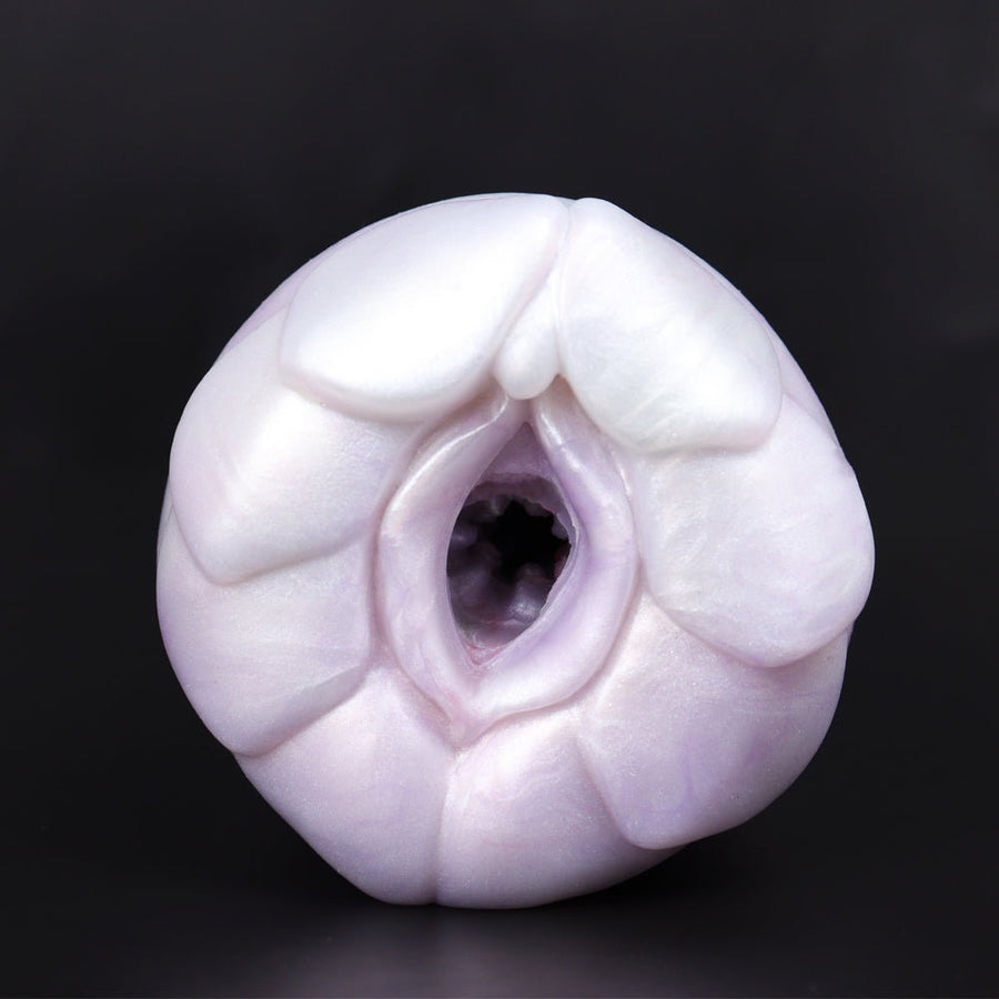 Pastel white silicone stroker with oval opening and molded ridges, front view.