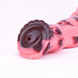 Close-up of Arion dildo tip and base suction pad, black opening on pink marbling