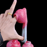 Pink cock ring with translucent strap-style base ring, shown from side/top view.
