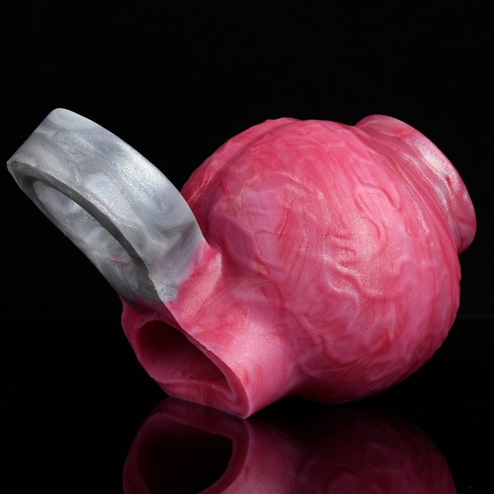 Pink enlargement sleeve with translucent strap and textured surface, angled view.