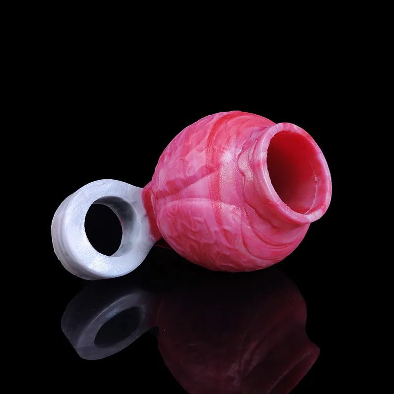 Pink cock ring with curved translucent base ring and a circular side opening.