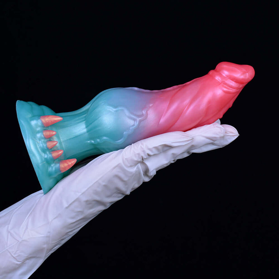 Teal-and-pink alien animal sex toy with spiked flared base and red tip