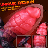 Pink dragon-scale anal plug close-up, curved shape with textured midsection