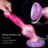 Pink dog-shaped dildo with purple knot base and strong suction cup; tube attached