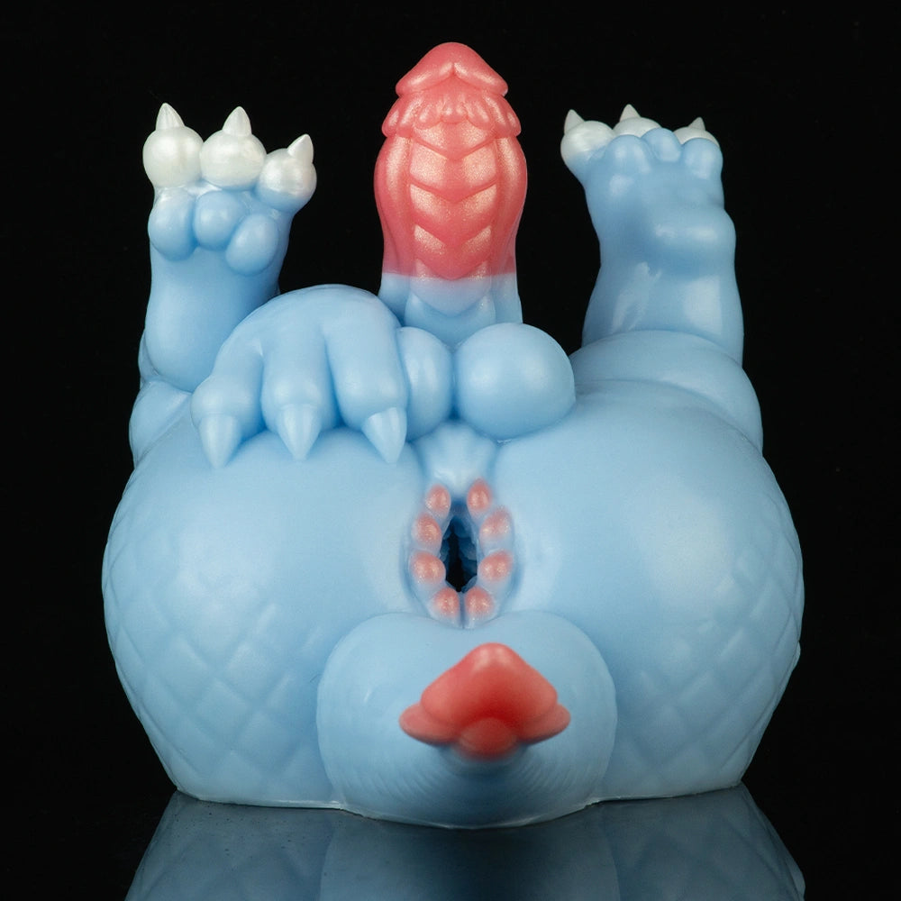 Light blue dragon toy with white horns and raised pink tail, front view