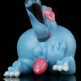 Light blue dragon toy with pink head crest and paw detail, prone side view