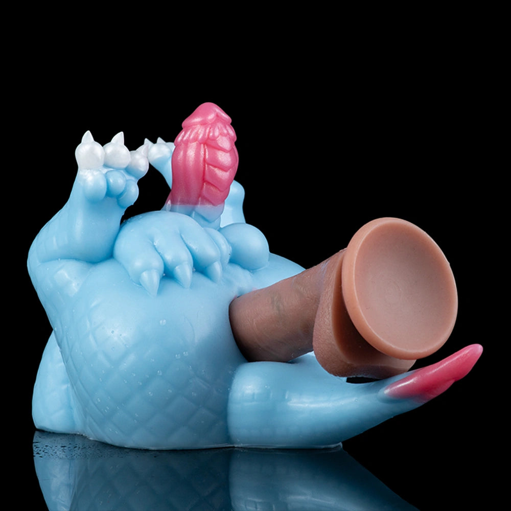 Light blue dragon toy with pink crest and raised base, brown inner sleeve visible