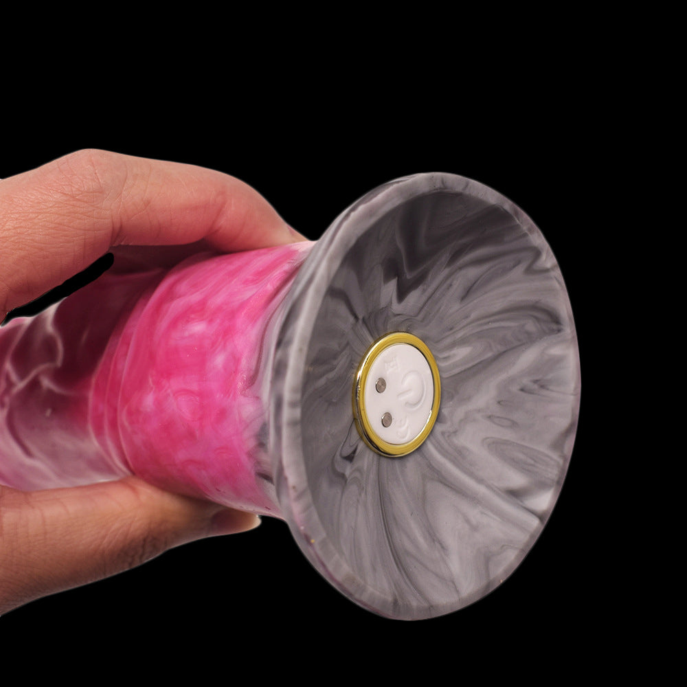 Close-up of flared base front with button detail on pink marbled vibrator