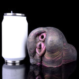Animal-style dual-hole sex toy beside white/clear measuring size marker