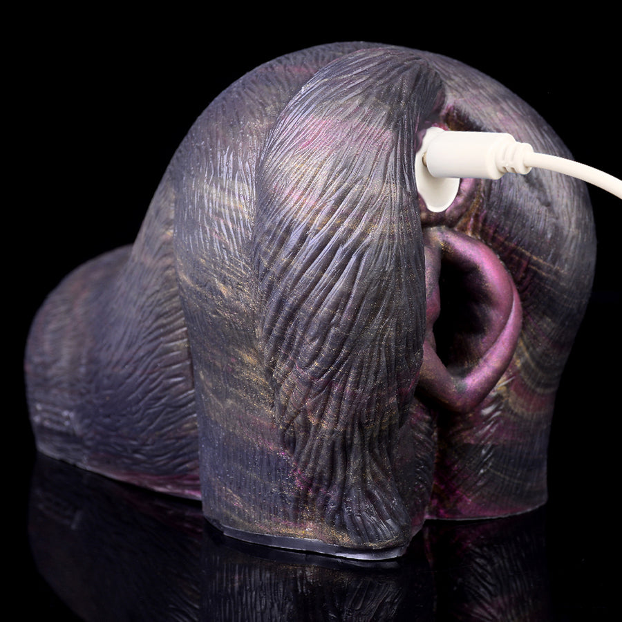 Grey animal-shaped dual-hole masturbator with white plug and purple openings