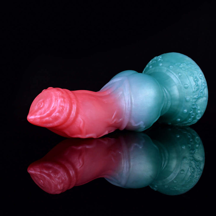 Curved pink-and-blue sex toy with bulbous knot base and glossy ridged texture