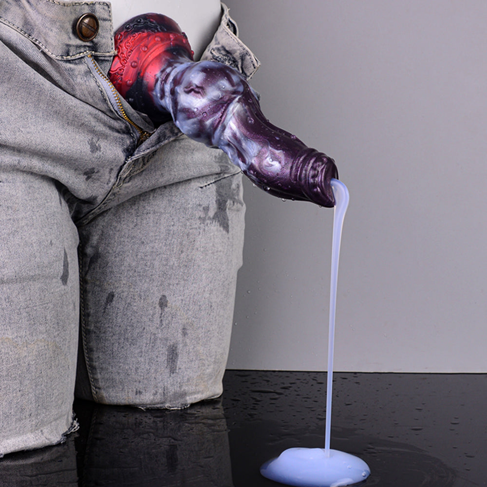 Gloved hand holds purple-and-red knot dildo with clear tube