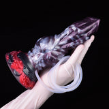 Purple-and-red knot dildo with clear tube coiled near base, in glove