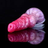 Dildo “alien” en vista lateral: punta con agujero y manguera transparente