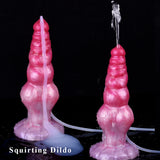 Dildo “alien” fucsia con chorro simulado; manguera transparente y base ancha