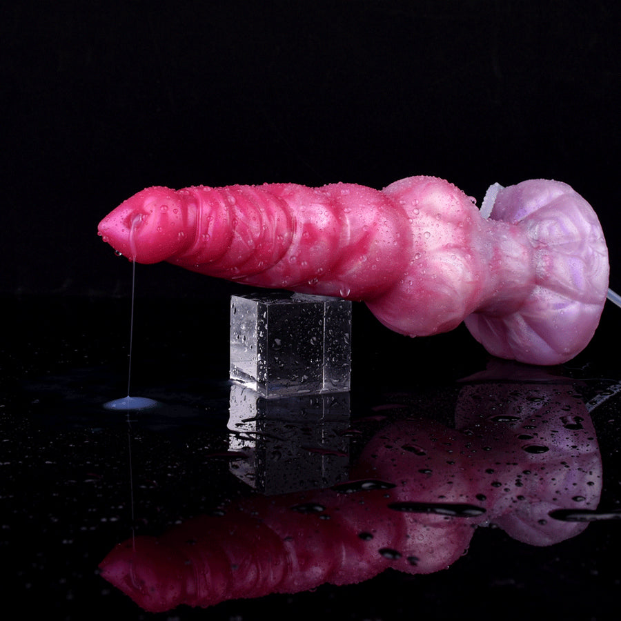 Pink and purple ridged alien-style squirting dildo lying with reflected base