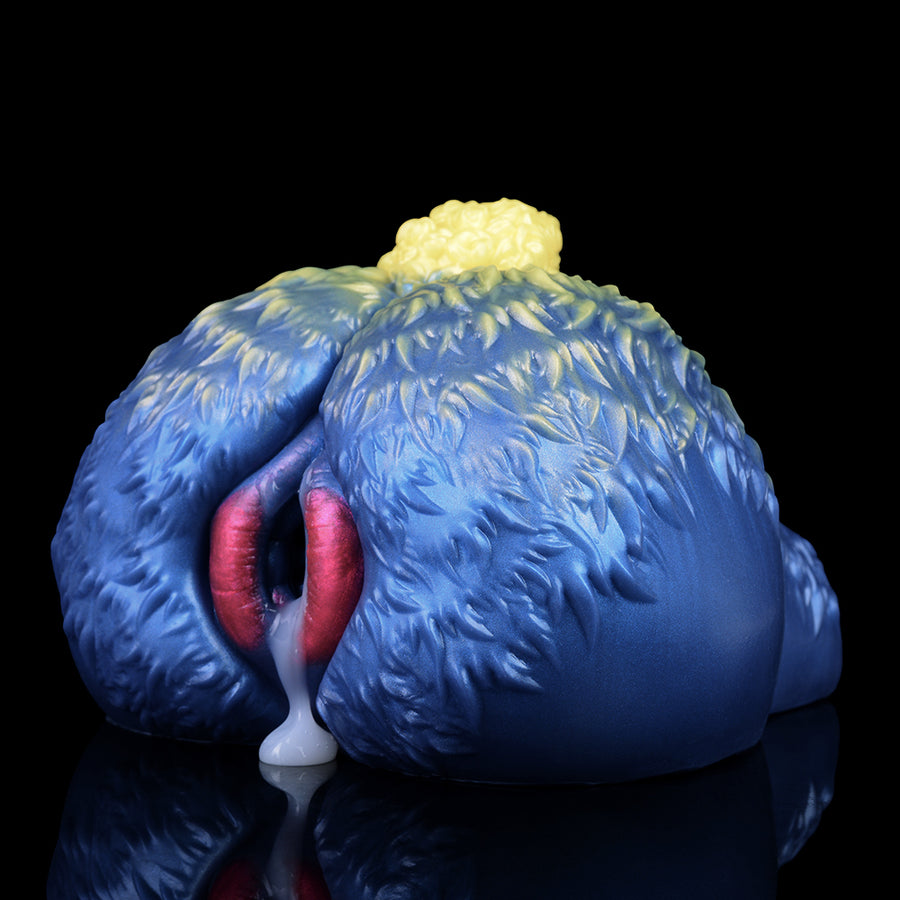 Blue sheep-shaped novelty sex toy with red-pink opening and yellow tuft, rear view