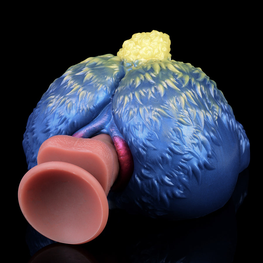 Blue animal-shaped novelty sex toy with cream tuft, close view of open end