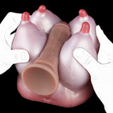 Pink silicone anatomical toy with red tips, underside view with gloves