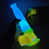 Luminous blue horse vibrator held near screen, glowing base and nozzle tip